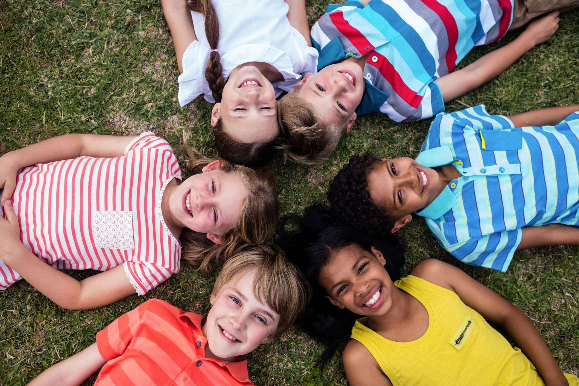 Happy children smiling together in a circle