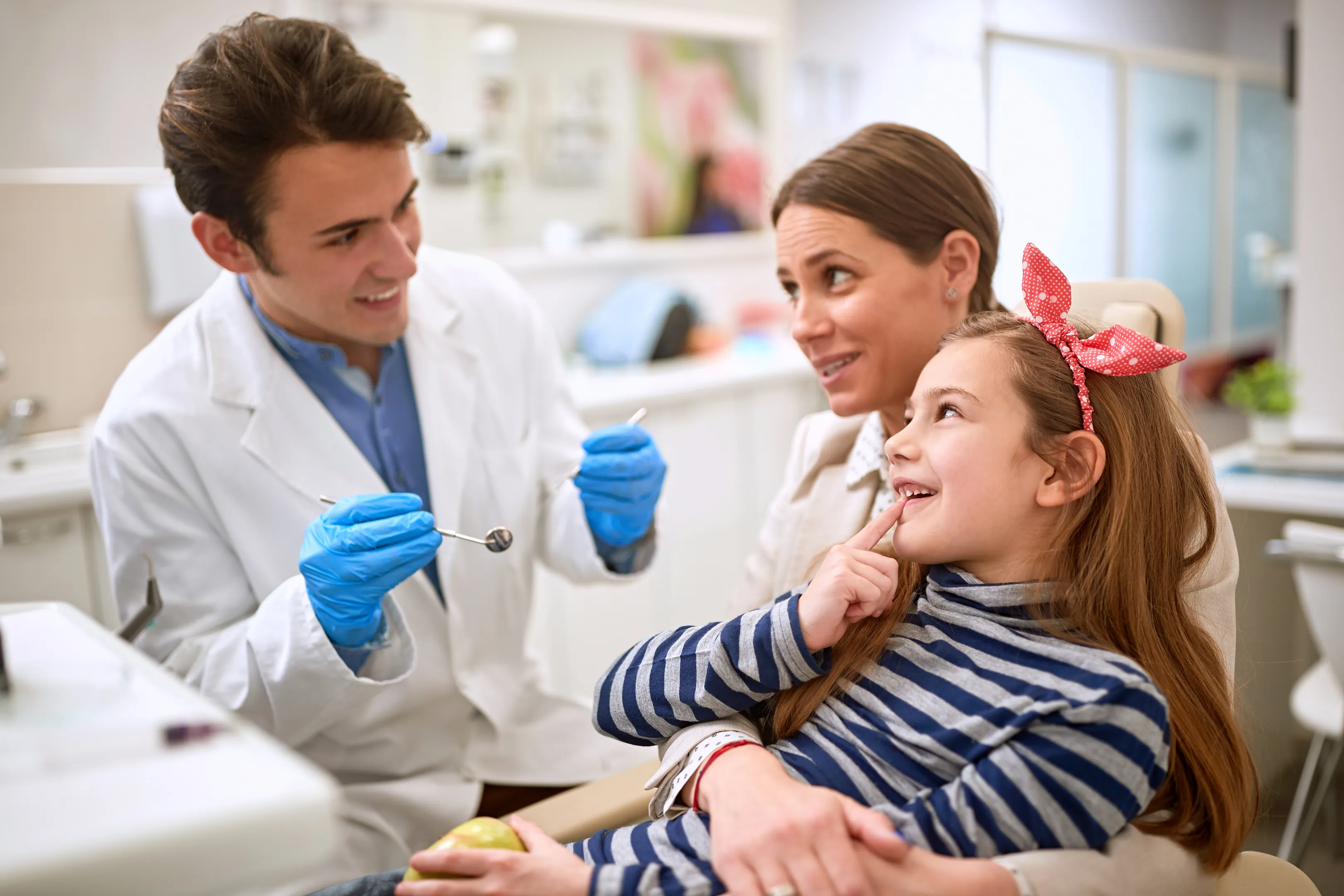 Happy parent and child during positive pediatric dental experience