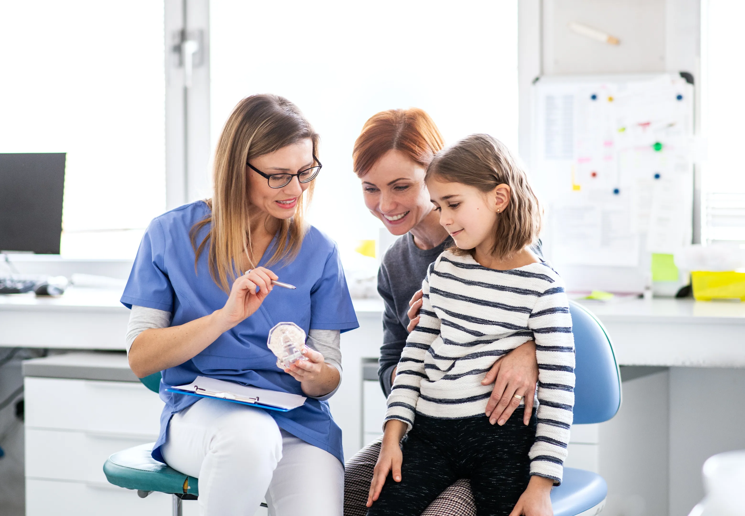 Dentist examining pediatric patient gently